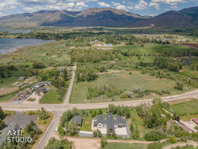 1188 South Old Trappers Loop Road Huntsville, UT 84317 - Photo 88 of 92 Aerial perspective showcasing a sprawling landscape with a prominent body of water, distant mountains, and extensive green fields