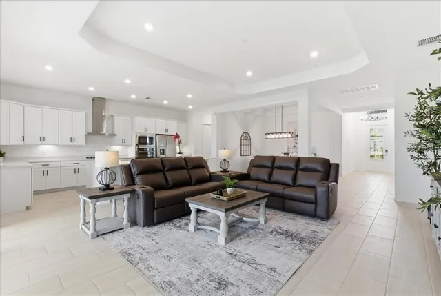 a living room with furniture and kitchen view