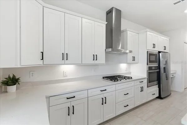 a kitchen with stainless steel appliances white cabinets and a sink