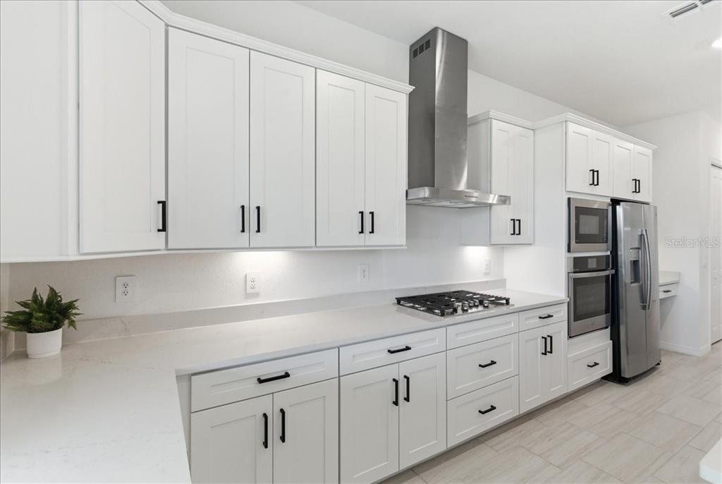 19168 Cherrystone Way Lakewood Ranch, FL 34211 - Photo 13 of 23 a kitchen with stainless steel appliances white cabinets and a sink