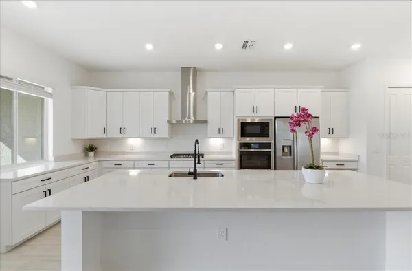 a kitchen with stainless steel appliances a sink and a refrigerator