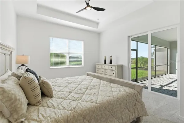 a bedroom with a bed and a large window