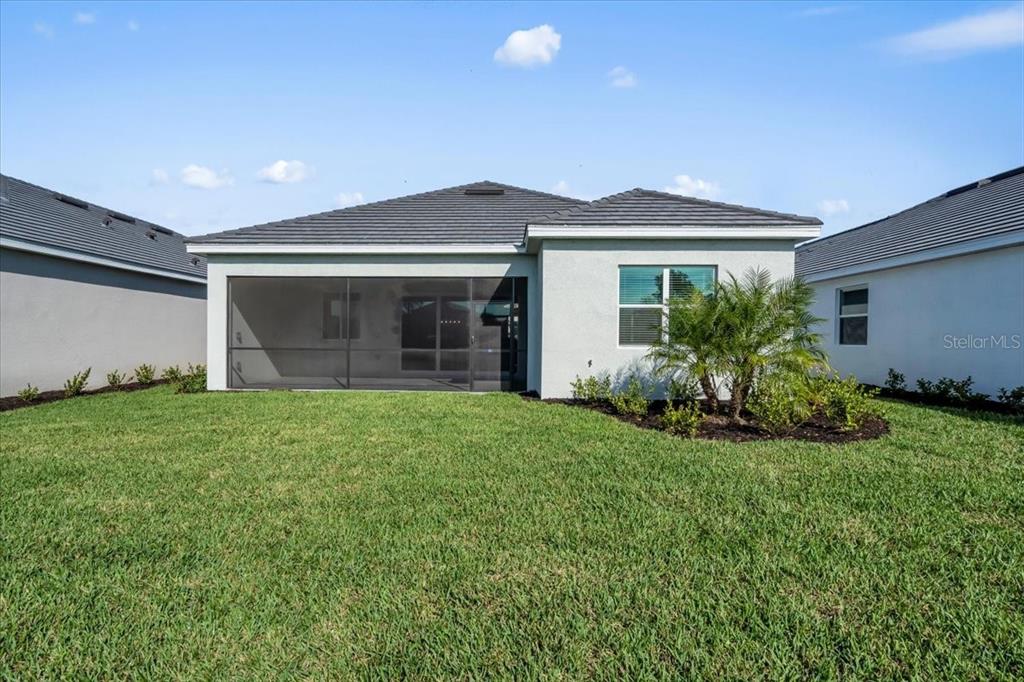 19168 Cherrystone Way Lakewood Ranch, FL 34211 - Photo 20 of 23 a front view of a house with garden