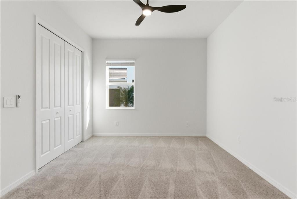 19168 Cherrystone Way Lakewood Ranch, FL 34211 - Photo 7 of 23 an empty room with a ceiling fan and windows