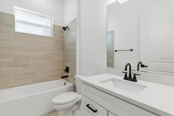 a bathroom with a sink a toilet and a tub