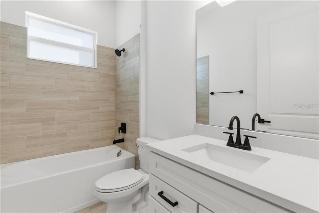 19168 Cherrystone Way Lakewood Ranch, FL 34211 - Photo 9 of 23 a bathroom with a sink a toilet and a tub