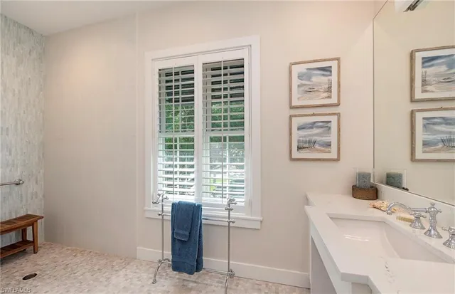 a bathroom with a sink and a window