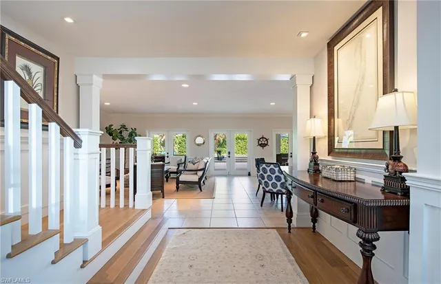 a living room with lots of furniture and a large window
