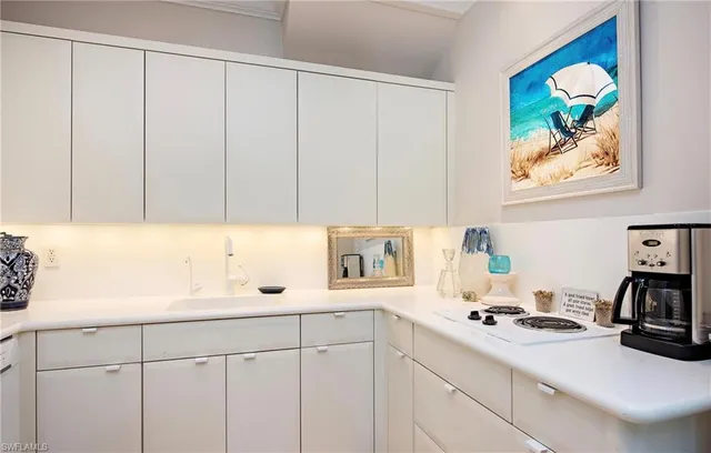 a kitchen with a sink cabinets and appliances