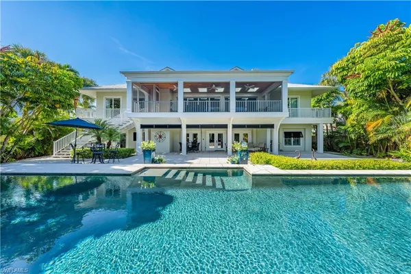 a view of a house with swimming pool and a yard