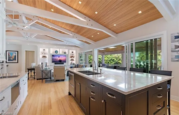 a kitchen with sink cabinets and living room view