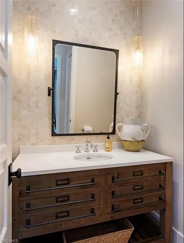 a bathroom with a sink vanity and a mirror