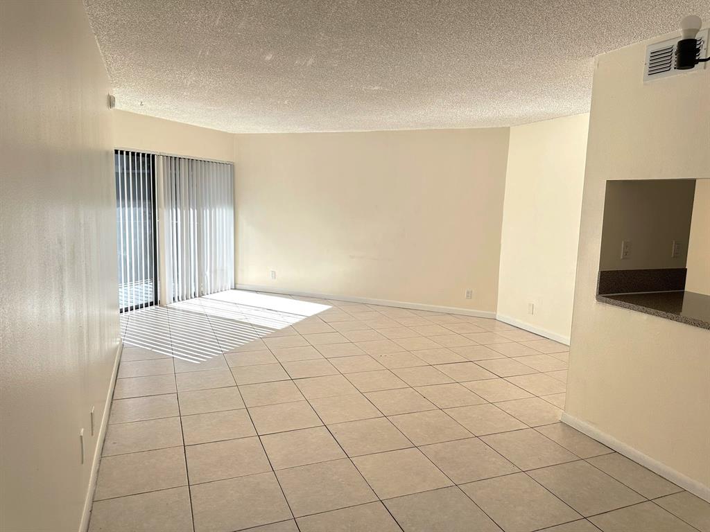 1850 North Congress Avenue, Unit 208 West Palm Beach, FL 33401 - Photo 3 of 15 a view of an empty room and window