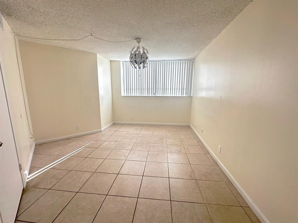 1850 North Congress Avenue, Unit 208 West Palm Beach, FL 33401 - Photo 7 of 15 a view of an empty room and window