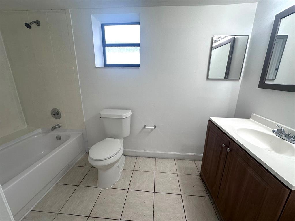 1850 North Congress Avenue, Unit 208 West Palm Beach, FL 33401 - Photo 8 of 15 a bathroom with a sink toilet and shower