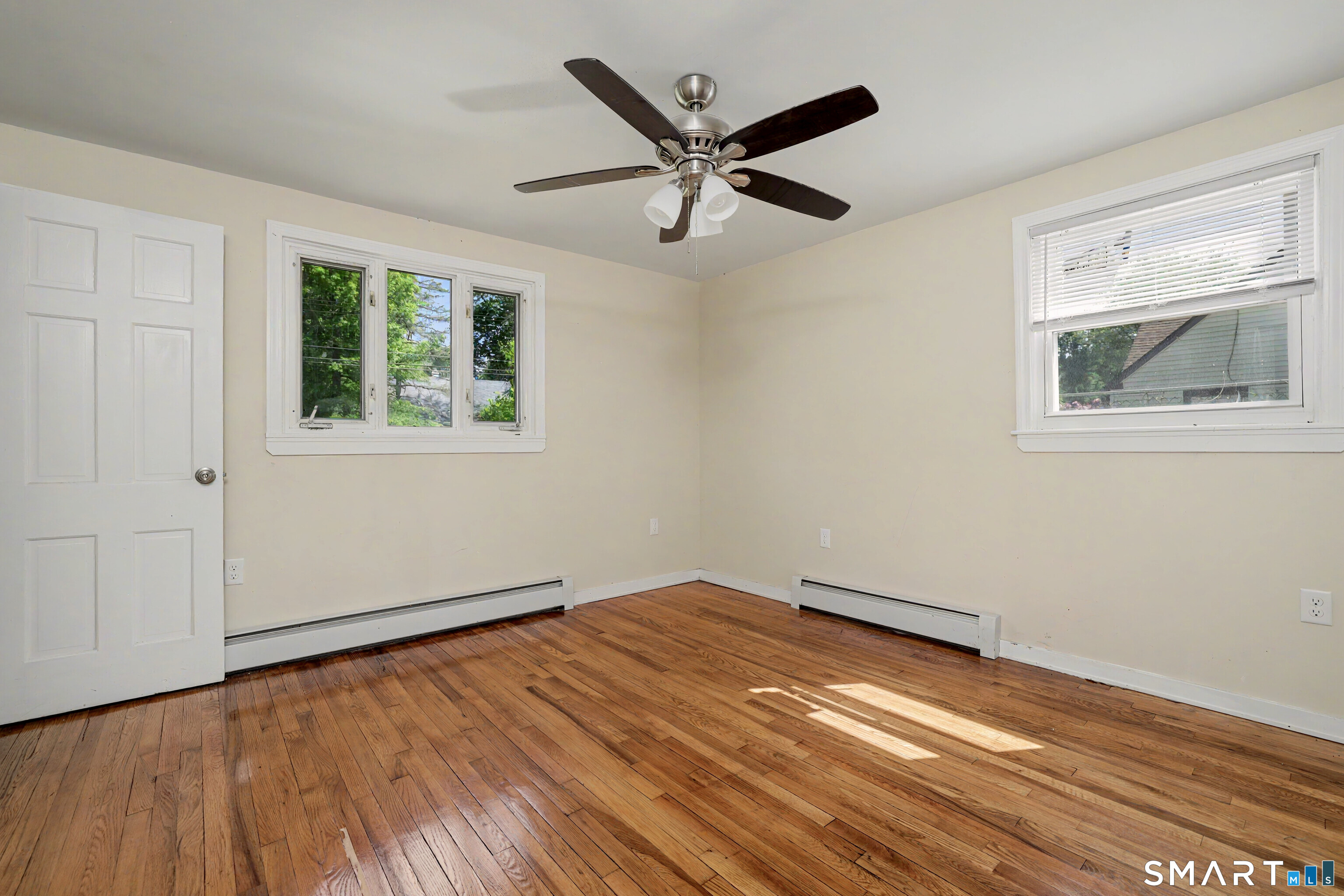 97 Boothbay Street Bloomfield, CT 06002 - Photo 16 of 33 a view of empty room with wooden floor and fan