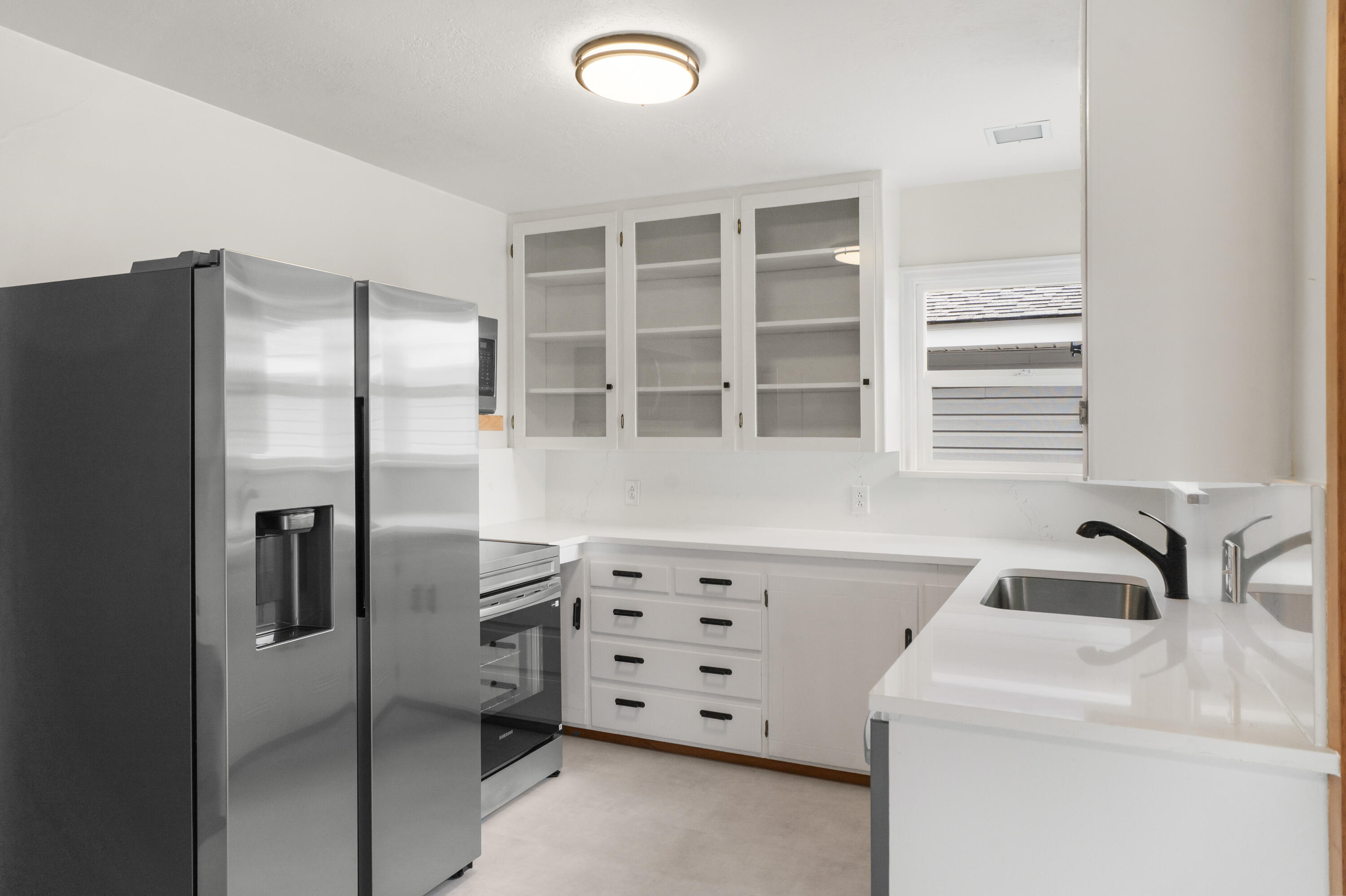 946 Southwest 13th Street Redmond, OR 97756 - Photo 12 of 49 a kitchen with a refrigerator and a sink