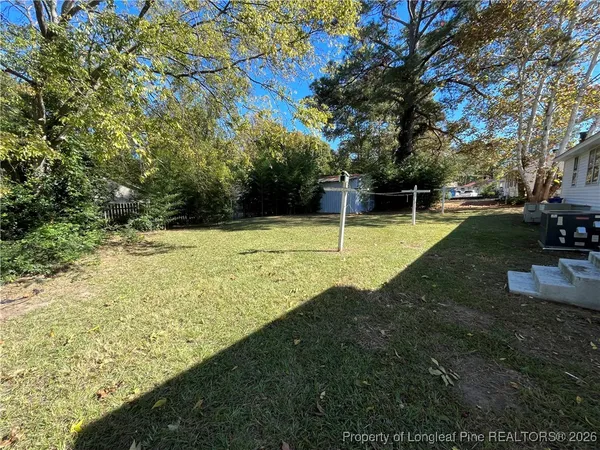 a view of a backyard with large trees