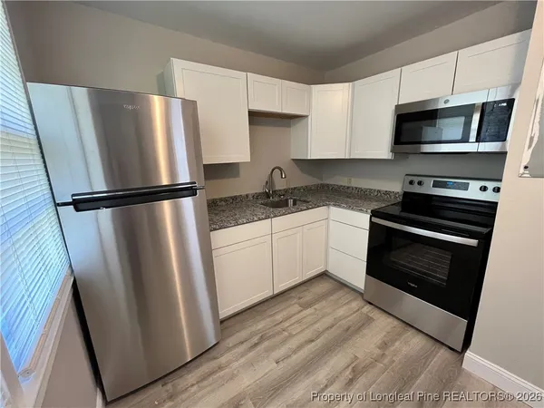a kitchen with a refrigerator sink and microwave
