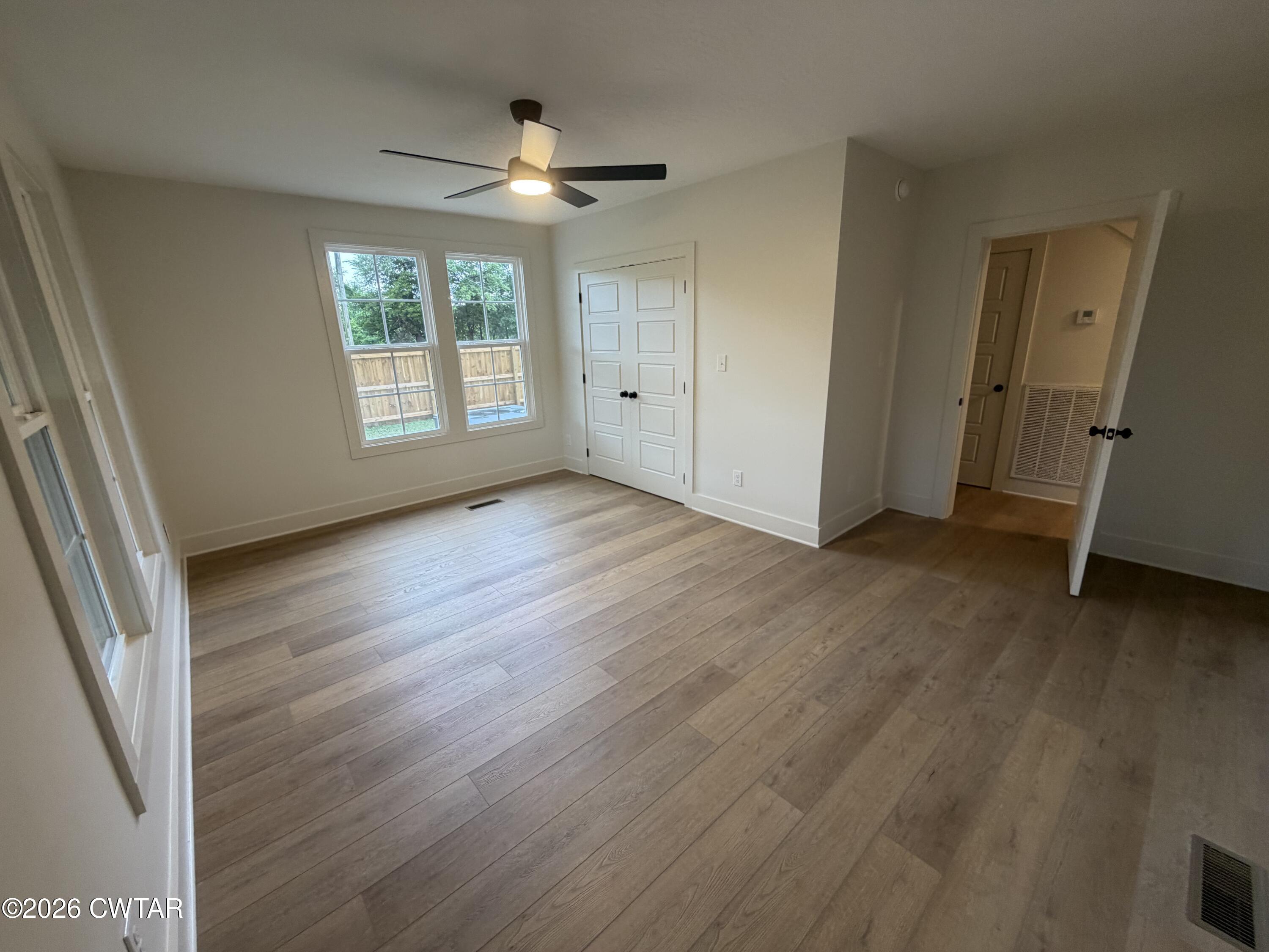 16 Manner Frank Road Milan, TN 38358 - Photo 16 of 25 a view of an empty room with wooden floor and a window