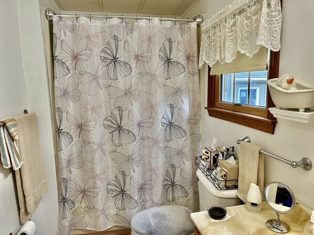 45 Clems Way Acushnet, MA 02743 - Photo 13 of 18 a bathroom with a sink and a shower curtain