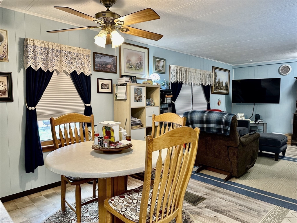 45 Clems Way Acushnet, MA 02743 - Photo 6 of 18 a living room with furniture kitchen view and a flat screen tv