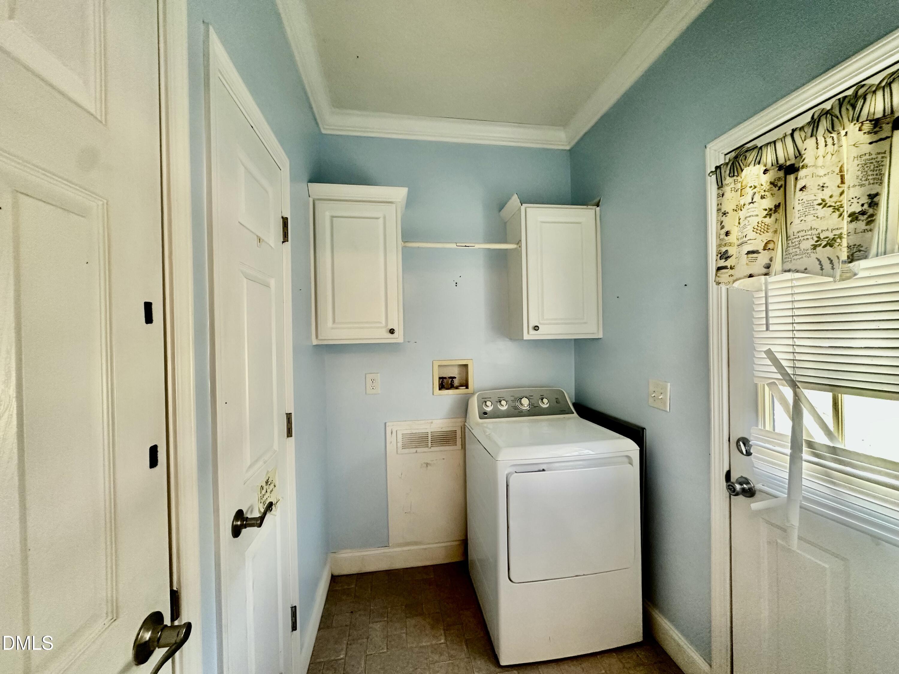 155 Collin Drive Roxboro, NC 27574 - Photo 14 of 20 a utility room with cabinets washer and dryer