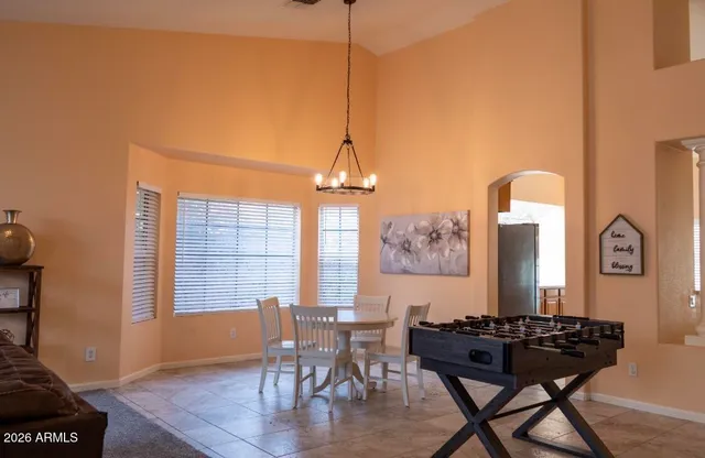 a view of a dining room with furniture and window