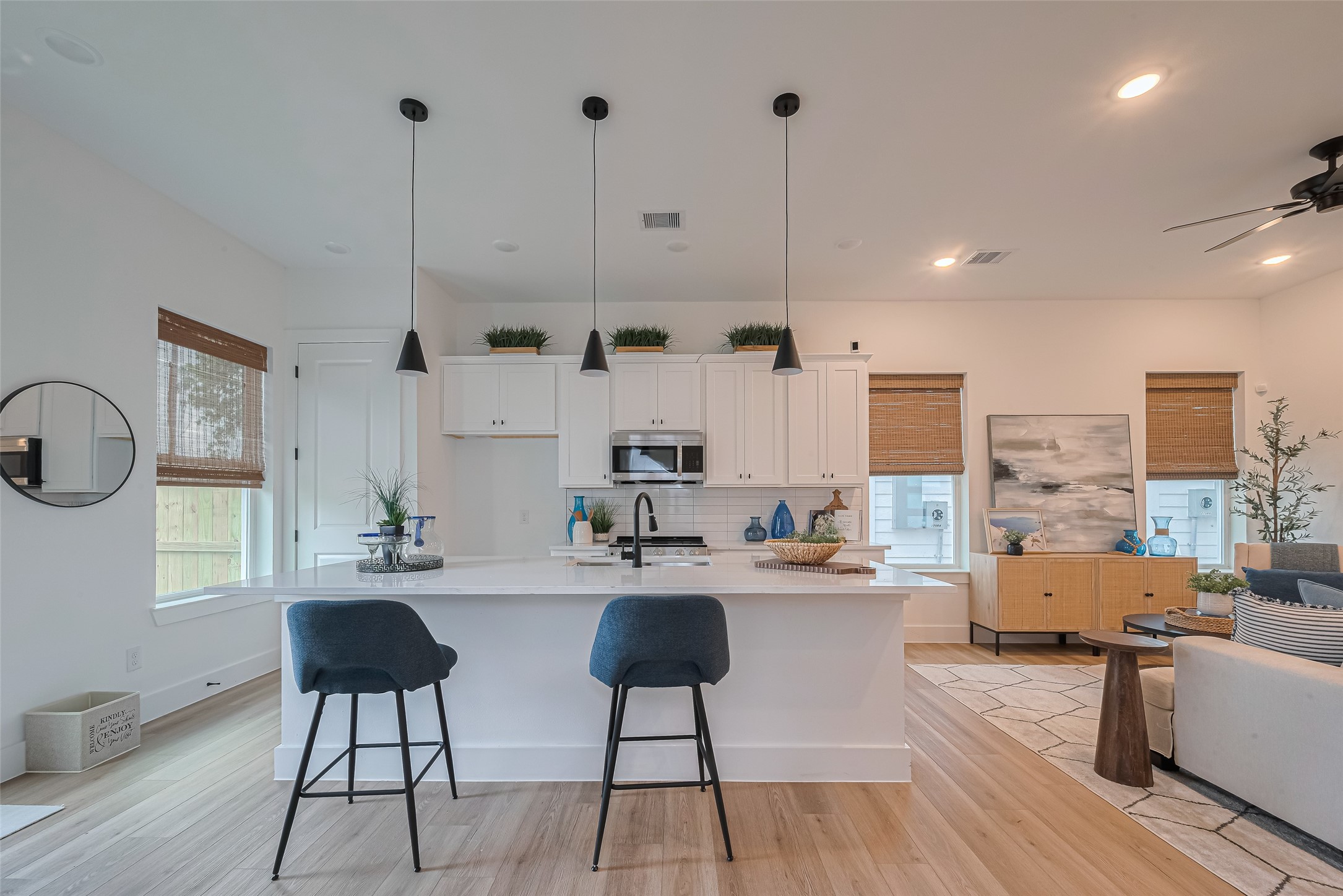 1462 Ferguson Way Houston, TX 77088 - Photo 13 of 24 a kitchen with stainless steel appliances kitchen island granite countertop a stove a sink a dining table and chairs with wooden floor