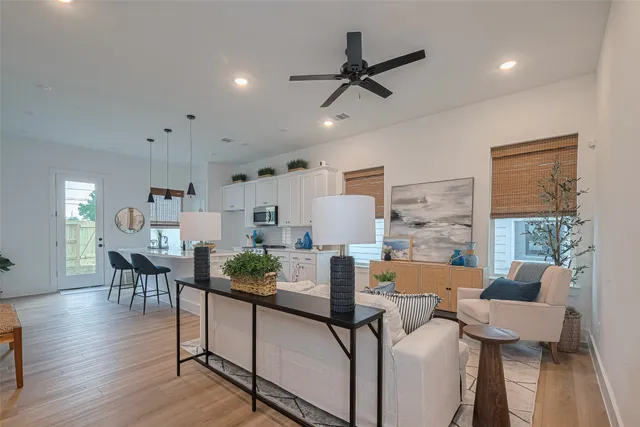 a living room with furniture and a wooden floor
