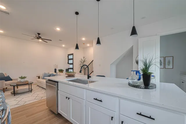 a living room with furniture and a painting on the wall