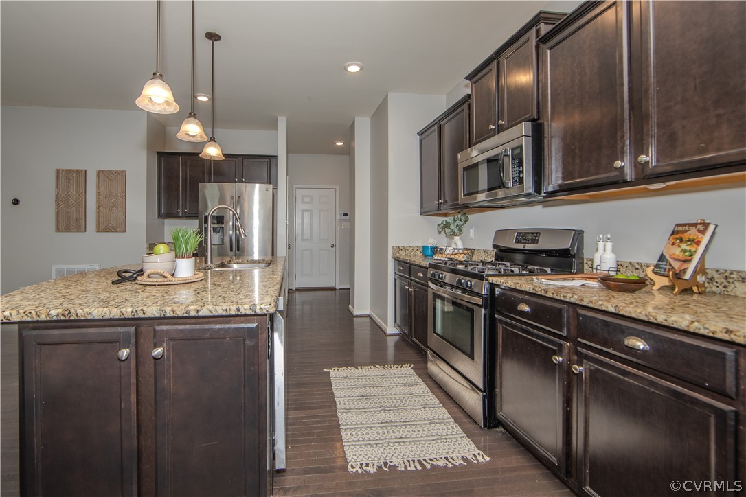 7649 Nicklaus Circle Moseley, VA 23120 - Photo 10 of 36 a kitchen with stainless steel appliances granite countertop a stove a sink and a refrigerator
