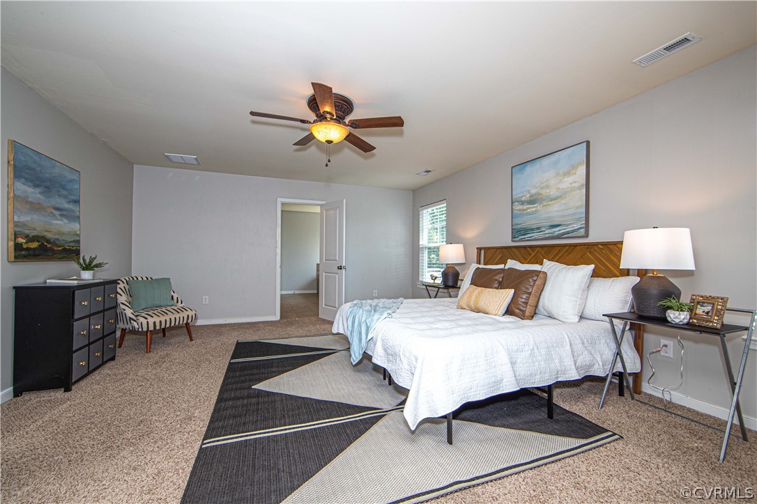 7649 Nicklaus Circle Moseley, VA 23120 - Photo 16 of 36 a bedroom with a bed and a chandelier