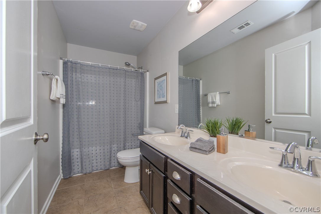 7649 Nicklaus Circle Moseley, VA 23120 - Photo 24 of 36 a bathroom with a sink a toilet a shower and a mirror
