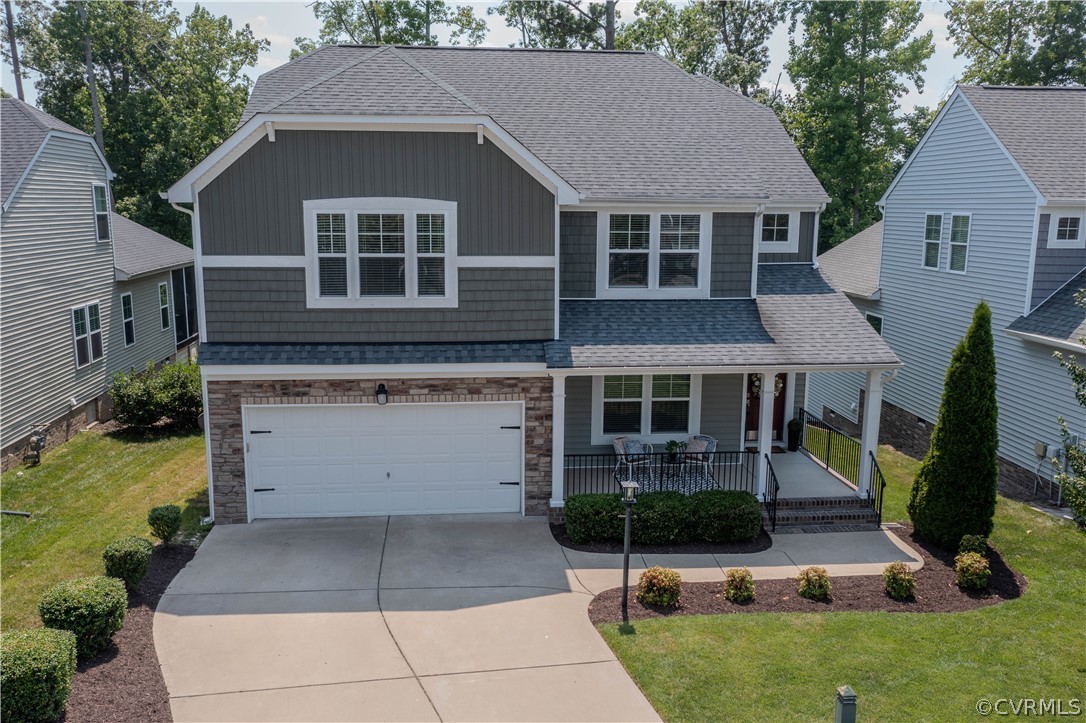 7649 Nicklaus Circle Moseley, VA 23120 - Photo 27 of 36 a front view of a house with garden