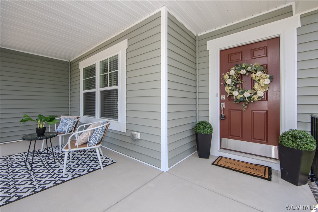 7649 Nicklaus Circle Moseley, VA 23120 - Photo 3 of 36 a view of house with chairs and potted plant