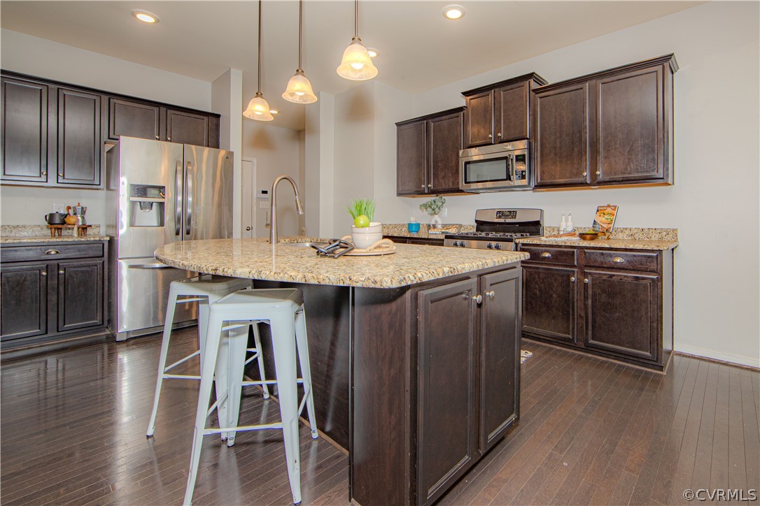 7649 Nicklaus Circle Moseley, VA 23120 - Photo 8 of 36 a kitchen with stainless steel appliances granite countertop wooden cabinets a refrigerator a stove a sink and a wooden floors