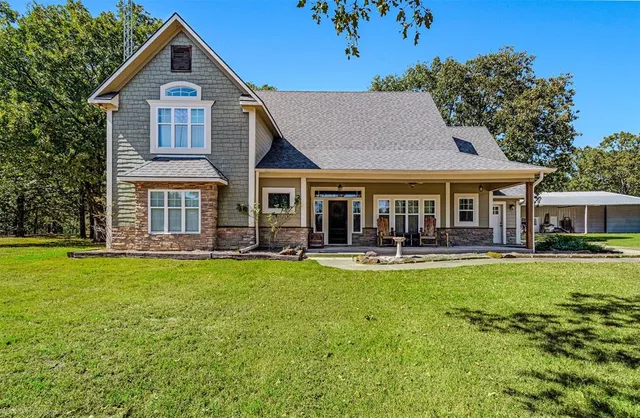 a front view of a house with swimming pool having outdoor seating
