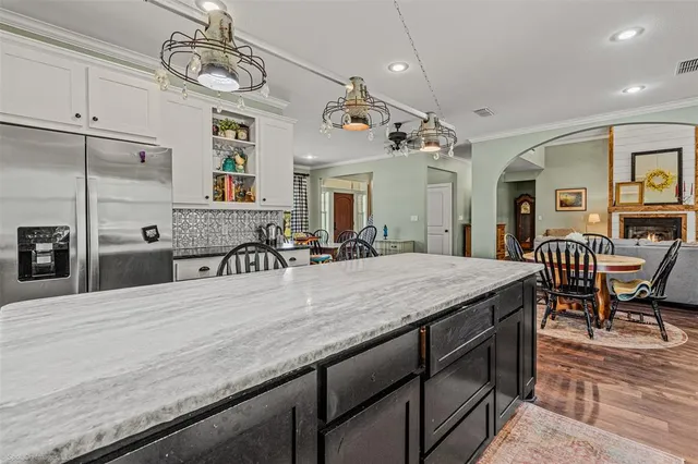 a view of a dining room kitchen island with furniture and a chandelier