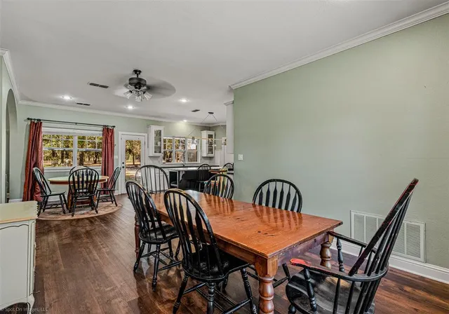 a view of a dining room with furniture and wooden floor