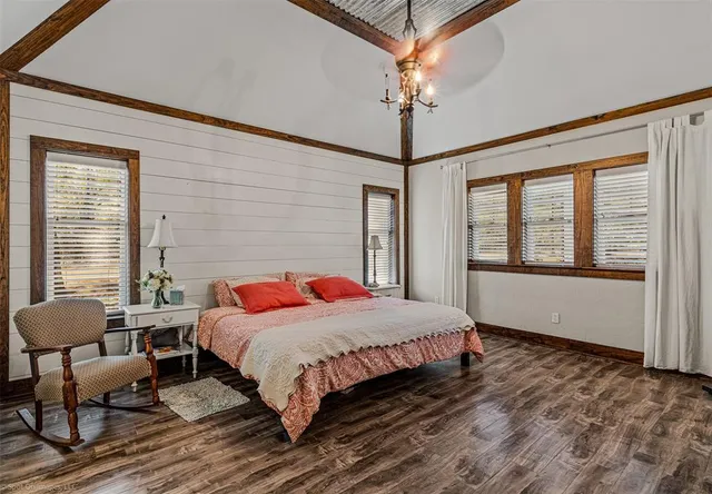 a bedroom with a bed and a chandelier