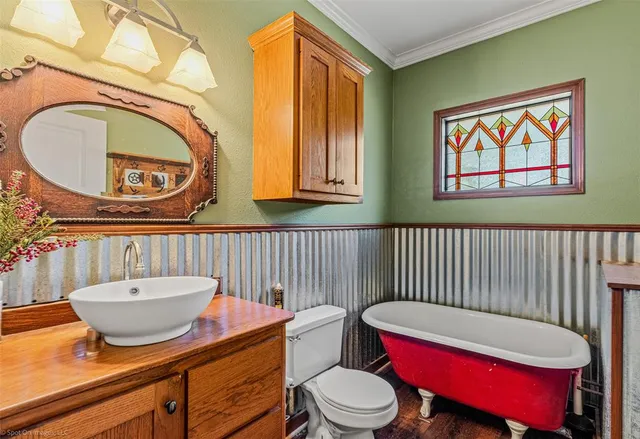 a bathroom with a toilet a sink and a mirror