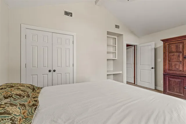a bedroom with a bed and a closet
