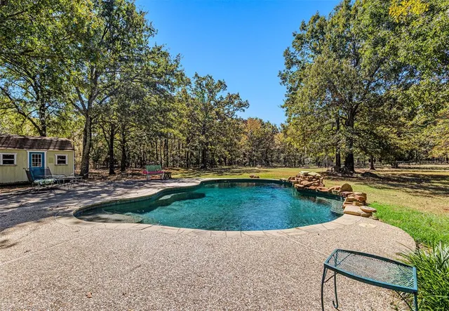 a view of a swimming pool with a yard