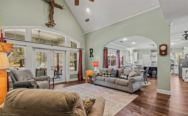 a living room with furniture ceiling fan and a rug