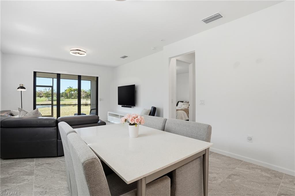 1645 Serena Avenue Naples, FL 34120 - Photo 13 of 43 a view of a dining room with furniture and a large window