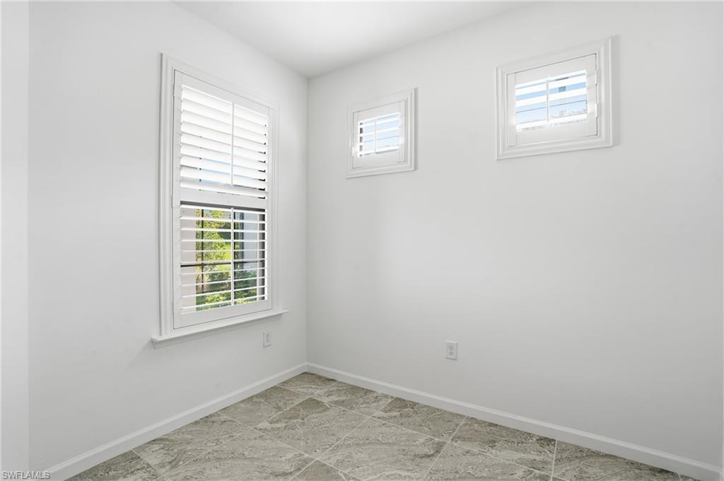 1645 Serena Avenue Naples, FL 34120 - Photo 15 of 43 an empty room with windows