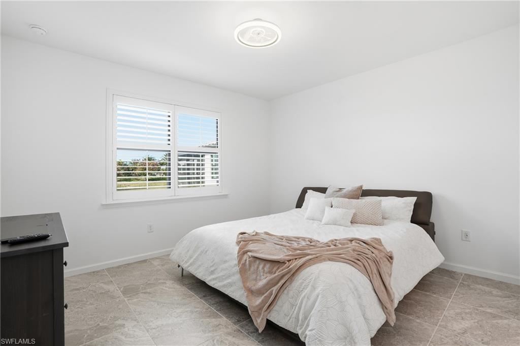 1645 Serena Avenue Naples, FL 34120 - Photo 17 of 43 a bedroom with a bed and a window