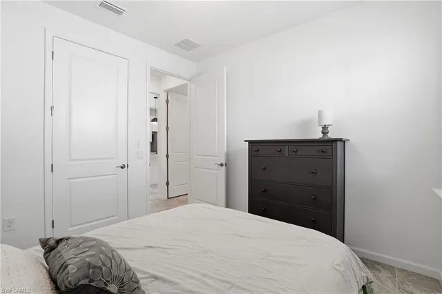 a bedroom with a bed and a dresser