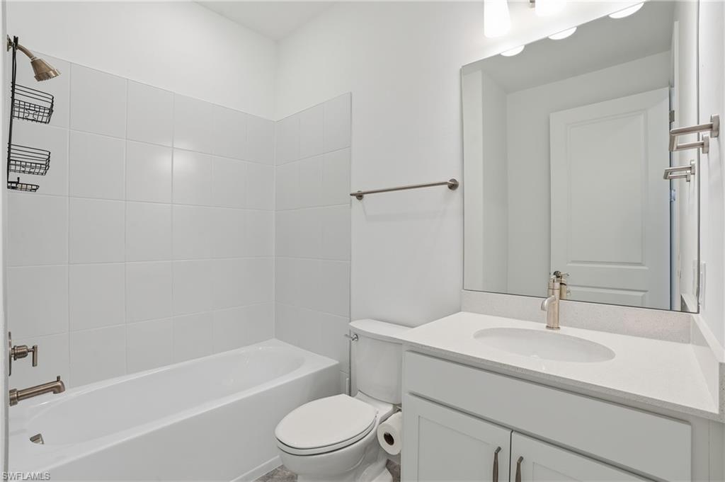 1645 Serena Avenue Naples, FL 34120 - Photo 24 of 43 a bathroom with a sink a toilet and bathtub